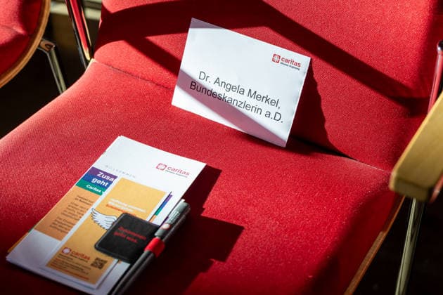 Augsburg, Bavaria, Germany - September 25, 2026: Former German Chancellor Angela Merkel (CDU) at the Caritas Elisabeth Prize award ceremony in the Golden Hall of Augsburg City Hall. Name tag on the chair of Dr. Angela Merkel, former German Chancellor.