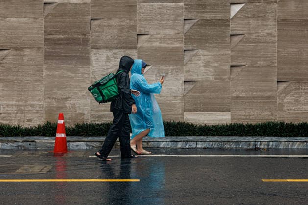 September 26, 2026, Thailand: A Grab delivery worker walks along a flooded street due to heavy rain in Bangkok, Thailand, Saturday, September 26, 2026. All 50 districts of Bangkok have been declared disaster areas and residents along canal areas have been advised to move to higher ground. Thailand - ZUMAm249 20260926_zip_m249_004 Copyright: xAndrexMalerbax