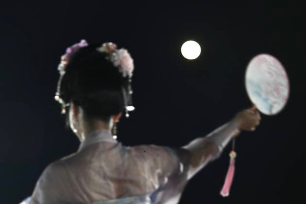 RECORD DATE NOT STATED Hong Kong daily life A performer in traditional Hanfu attire poses and a moon in Hung Hom New Waterfront the day after the Mid-Autumn Festival on September 26, 2026 in Hong Kong. (Photo by Kobe Li Nexpher Images) Hong Kong