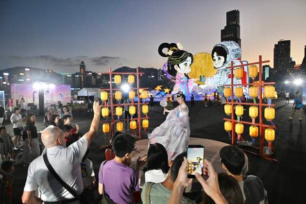 RECORD DATE NOT STATED Hong Kong daily life Visitors watch as a performer in traditional Hanfu attire performs in Hung Hom New Waterfront the day after the Mid-Autumn Festival on September 26, 2026 in Hong Kong. (Photo by Kobe Li Nexpher Images) Hong Kong