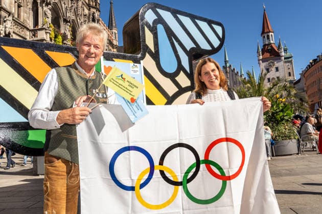 München wird deutscher Olympia-Bewerber, Verena Dietl, Sportbürgermeisterin der Stadt München, bei einer spontanen kleinen Feier vor Olympia-Maskottchen Dackel Waldi auf dem Marienplatz, München, 26. September 2026 Deutschland, München, 26. September 2026, Münchner Olympia-Bewerbung erfolgreich, München wird deutscher Olympia-Bewerber, Verena Dietl, Sportbürgermeisterin der Stadt München, 3. Bürgermeisterin, bei einer spontanen kleinen Feier mit Statement auf dem Marienplatz, mit dabei links ist Peter Mösbauer, Teil des Kommunikationsteams des BLSV, der die Olympia-Bewerbung unterstützt hat, Olympische Flagge, Olympia-Maskottchen Dackel Waldi auf dem Marienplatz, Münchner Olympia-Bewerbung mit drei Meter hohem Riesen-Dackel, Ma