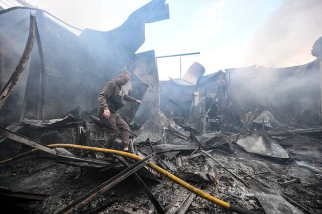 An entrepreneur walks through piles of burnt scrap metal among the destroyed rows of stalls at the Central Clothes Market (Anholenko) in Zaporizhzhia, Ukraine, September 26, 2026. The market sustained significant damage in a Russian drone attack. (Photo by Dmytro Smolienko Ukrinform) Russian troops strike clothes market in Zaporizhzhia  Copyright: xDmytroxSmolienkox