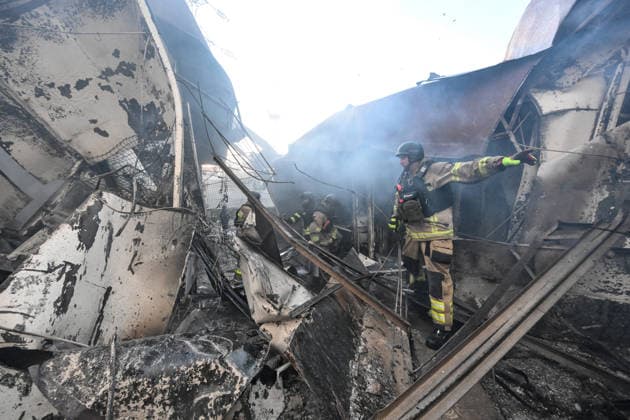 State Emergency Service rescuers work amid burnt-out metal containers at the Central Clothes Market (Anholenko) in Zaporizhzhia, Ukraine, September 26, 2026. The market sustained significant damage in a Russian drone attack. (Photo by Dmytro Smolienko Ukrinform) Russian troops strike clothes market in Zaporizhzhia  Copyright: xDmytroxSmolienkox