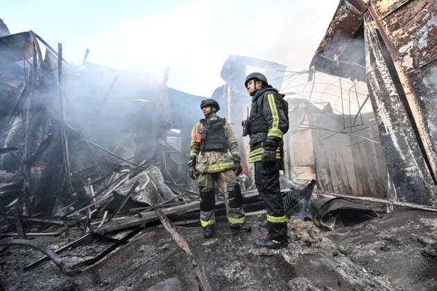 State Emergency Service rescuers work amid burnt-out metal containers at the Central Clothes Market (Anholenko) in Zaporizhzhia, Ukraine, September 26, 2026. The market sustained significant damage in a Russian drone attack. (Photo by Dmytro Smolienko Ukrinform) Russian troops strike clothes market in Zaporizhzhia  Copyright: xDmytroxSmolienkox