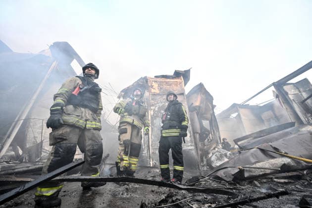 State Emergency Service rescuers work amid burnt-out metal containers at the Central Clothes Market (Anholenko) in Zaporizhzhia, Ukraine, September 26, 2026. The market sustained significant damage in a Russian drone attack. (Photo by Dmytro Smolienko Ukrinform) Russian troops strike clothes market in Zaporizhzhia  Copyright: xDmytroxSmolienkox