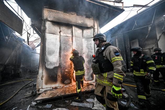 Russian troops strike clothes market in Zaporizhzhia A State Emergency Service rescuer uses a cut-off saw to open the deformed metal door of a shipping container while extinguishing a fire at the Central Clothes Market (Anholenko) in Zaporizhzhia, Ukraine, on September 26, 2026. The market sustained significant damage in a Russian drone attack. Zaporizhzhia Ukraine  Copyright: xDmytroxSmolienkox originalFilename: ukrinform-russiant260926_npvON.jpg