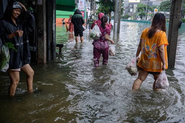 September 26, 2026, Bangkok, Thailand: BANGKOK, THAILAND, SEPTEMBER 26, 2026: Residents navigate flooded streets amid persistent heavy rain in Bangkok, Thailand. Continuous rainfall since September 24 caused widespread flooding across the capital, with nearly 300 millimeters of rain recorded in some areas. Bangkok authorities declared all 50 districts disaster-affected as floodwaters disrupted roads and residential communities. More heavy rain was forecast through September 27. Bangkok Thailand - ZUMAq101 20260926_zna_q101_106 Copyright: xWatsawatxKoktabtimx