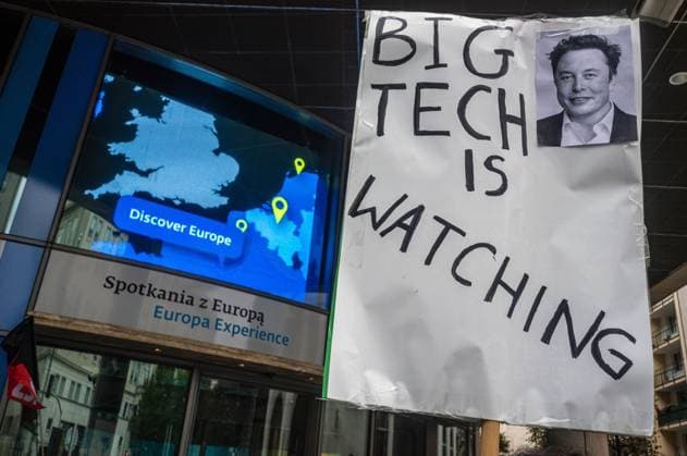 September 26, 2026, Warsaw, Mazovia, Poland: A placard that says Big Tech Is Watching next to a picture of Elon Musk is seen in front of the European Union building..Left-wing antifascist activists gather outside the European Union Commission building in Warsaw to protest against the Chat Control 1.0 legislation recently revived by the European Parliament. The legislation allows for the mass scanning of messages belonging to every European Union citizen for Child Sexual Abuse Material (CSAM) in the name of protecting children s rights and combating pedophilia. The activists, however, believe rights to privacy and the foundations of free speech are being trampled upon, especially with talks due to resume regarding the far more dangerous - ZUMAs197 20260926_aaa_s197_194 Copyright: xNeilxMiltonx