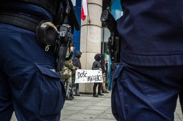 September 26, 2026, Warsaw, Mazovia, Poland: Protesters holding a banner that says, in Polish, Enough Surveillance are seen between two police officers..Left-wing antifascist activists gather outside the European Union Commission building in Warsaw to protest against the Chat Control 1.0 legislation recently revived by the European Parliament. The legislation allows for the mass scanning of messages belonging to every European Union citizen for Child Sexual Abuse Material (CSAM) in the name of protecting children s rights and combating pedophilia. The activists, however, believe rights to privacy and the foundations of free speech are being trampled upon, especially with talks due to resume regarding the far more dangerous Chat Contro - ZUMAs197 20260926_aaa_s197_195 Copyright: xNeilxMiltonx