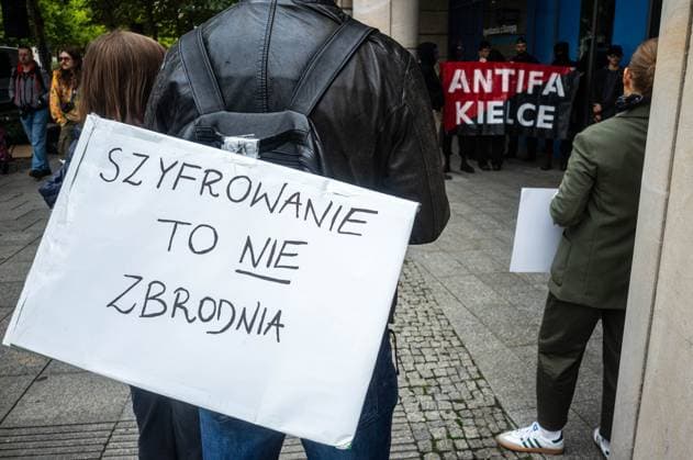 September 26, 2026, Warsaw, Mazovia, Poland: A placard that says, in Polish, encryption is not a crime is seen at the demonstration..Left-wing antifascist activists gather outside the European Union Commission building in Warsaw to protest against the Chat Control 1.0 legislation recently revived by the European Parliament. The legislation allows for the mass scanning of messages belonging to every European Union citizen for Child Sexual Abuse Material (CSAM) in the name of protecting children s rights and combating pedophilia. The activists, however, believe rights to privacy and the foundations of free speech are being trampled upon, especially with talks due to resume regarding the far more dangerous Chat Control 2.0 bill, which - ZUMAs197 20260926_aaa_s197_198 Copyright: xNeilxMiltonx