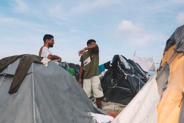 September 26, 2026, Ceuta, Ceuta, Spain: Migrants stand among tents and makeshift shelters at an informal settlement on the coast of Ceuta. Thousands of migrants, most of them young Moroccan men, have been living in makeshift settlements in the Spanish North African enclave of Ceuta since a mass arrival at the end of July 2026 set off a migration and political crisis. Ceuta Spain  - ZUMAs392 20260926_zip_s392_002 Copyright: xFabianxSuspensivox