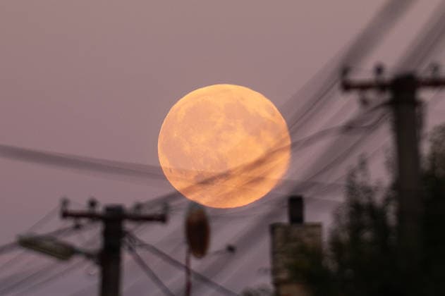 Full harvest Moon rises above the Slovak-Ukrainian border CIERNA, SLOVAKIA - SEPTEMBER 26: The full Harvest Moon rises above the Slovak-Ukrainian border near Cierna, Slovakia, on September 26, 2026. The orange-hued Moon, with its prominent craters and dark lunar plains visible, appears above the village as evening falls. Known as the Harvest Moon, September’s full moon is traditionally associated with the full moon closest to the autumnal equinox and historically provided farmers with additional light for working in the fields after sunset. Robert Nemeti Anadolu Cierna Slovakia. Editorial use only. Please get in touch for any other usage.  Copyright: x2026xAnadoluxRobertxNemetix