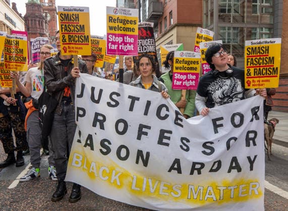 September 26, 2026, Manchester, United Kingdom: Justice for professor Jason Arday banner being held by Black Lives matter supporters. Activists in Manchester march for Stand Up To Racism against the far right. In addition to anti-racist slogans promoting diversity and migrant rights, demonstrators carried banners of the RNLI (Royal National Lifeboat Institution) following recent Patriot Platform protests. The broad coalition of trade unions, community groups, and political organisations featured prominent banners from BECTU (Broadcasting, Entertainment, Communications and Theatre Union) and Jewish Voice for Labour (JVL). Manchester, United Kingdom. Manchester United Kingdom - ZUMAs197 20260926_aaa_s197_211 Copyright: xGaryxRobertsx