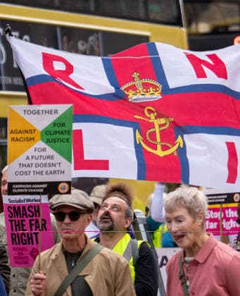 September 26, 2026, Manchester, United Kingdom: Protesters hold a banner with RNLI (Royal National Lifeboat Institution) during the rally. Activists in Manchester march for Stand Up To Racism against the far right. In addition to anti-racist slogans promoting diversity and migrant rights, demonstrators carried banners of the RNLI (Royal National Lifeboat Institution) following recent Patriot Platform protests. The broad coalition of trade unions, community groups, and political organisations featured prominent banners from BECTU (Broadcasting, Entertainment, Communications and Theatre Union) and Jewish Voice for Labour (JVL). Manchester, United Kingdom. Manchester United Kingdom - ZUMAs197 20260926_aaa_s197_213 Copyright: xGaryxRobertsx