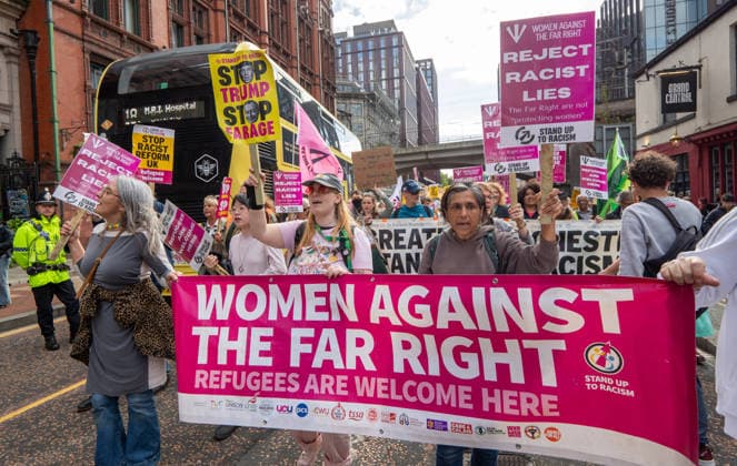 September 26, 2026, Manchester, United Kingdom: Protesters hold a Woman against the far right banner during the rally. Activists in Manchester march for Stand Up To Racism against the far right. In addition to anti-racist slogans promoting diversity and migrant rights, demonstrators carried banners of the RNLI (Royal National Lifeboat Institution) following recent Patriot Platform protests. The broad coalition of trade unions, community groups, and political organisations featured prominent banners from BECTU (Broadcasting, Entertainment, Communications and Theatre Union) and Jewish Voice for Labour (JVL). Manchester, United Kingdom. Manchester United Kingdom - ZUMAs197 20260926_aaa_s197_214 Copyright: xGaryxRobertsx
