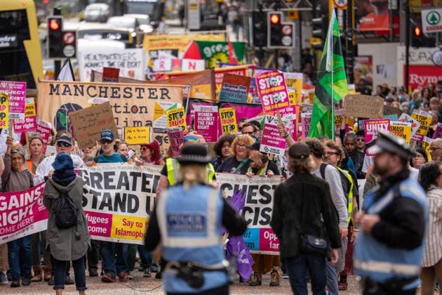 September 26, 2026, Manchester, United Kingdom: Police liaison officers watch approaching marchers during the rally. Activists in Manchester march for Stand Up To Racism against the far right. In addition to anti-racist slogans promoting diversity and migrant rights, demonstrators carried banners of the RNLI (Royal National Lifeboat Institution) following recent Patriot Platform protests. The broad coalition of trade unions, community groups, and political organisations featured prominent banners from BECTU (Broadcasting, Entertainment, Communications and Theatre Union) and Jewish Voice for Labour (JVL). Manchester, United Kingdom. Manchester United Kingdom - ZUMAs197 20260926_aaa_s197_215 Copyright: xGaryxRobertsx
