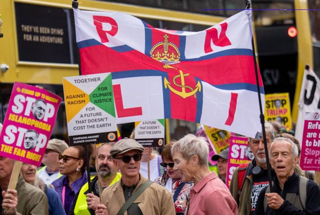 September 26, 2026, Manchester, United Kingdom: Protesters hold a banner with RNLI (Royal National Lifeboat Institution) during the rally. Activists in Manchester march for Stand Up To Racism against the far right. In addition to anti-racist slogans promoting diversity and migrant rights, demonstrators carried banners of the RNLI (Royal National Lifeboat Institution) following recent Patriot Platform protests. The broad coalition of trade unions, community groups, and political organisations featured prominent banners from BECTU (Broadcasting, Entertainment, Communications and Theatre Union) and Jewish Voice for Labour (JVL). Manchester, United Kingdom. Manchester United Kingdom - ZUMAs197 20260926_aaa_s197_217 Copyright: xGaryxRobertsx