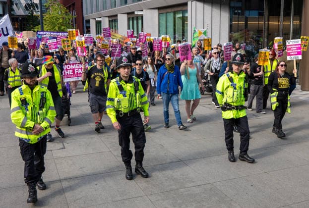 September 26, 2026, Manchester, United Kingdom: Police officers lead marchers past Number10 North during the rally. Activists in Manchester march for Stand Up To Racism against the far right. In addition to anti-racist slogans promoting diversity and migrant rights, demonstrators carried banners of the RNLI (Royal National Lifeboat Institution) following recent Patriot Platform protests. The broad coalition of trade unions, community groups, and political organisations featured prominent banners from BECTU (Broadcasting, Entertainment, Communications and Theatre Union) and Jewish Voice for Labour (JVL). Manchester, United Kingdom. Manchester United Kingdom - ZUMAs197 20260926_aaa_s197_219 Copyright: xGaryxRobertsx