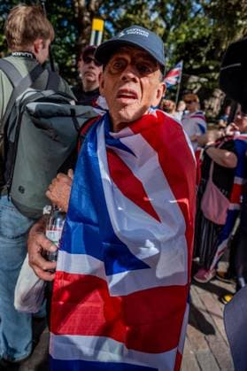 September 26, 2026, London, United Kingdom: An anti-migrant protestor draped in a Union Jack flag awaits the start of the Football Lads protest against grooming gangs targeting British girls. The event organised by Together For The Children in collaboration with Football Lads on National Survivors Day stands in solidarity with survivors of child sexual abuse and sexual violence while demanding stronger child protections and legal reforms, as well as a curb on illegal migration. London United Kingdom - ZUMAs197 20260926_aaa_s197_314 Copyright: xLabxMox