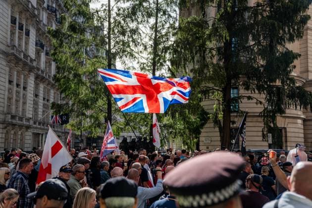 September 26, 2026, London, United Kingdom: The Union Jack flag is flown high during a protest against grooming gangs targeting British girls. The event organised by Together For The Children in collaboration with Football Lads on National Survivors Day stands in solidarity with survivors of child sexual abuse and sexual violence while demanding stronger child protections and legal reforms, as well as a curb on illegal migration. London United Kingdom - ZUMAs197 20260926_aaa_s197_311 Copyright: xLabxMox