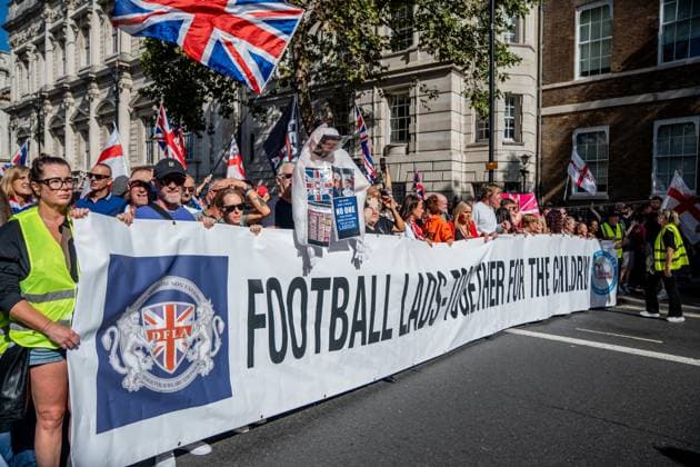 September 26, 2026, London, United Kingdom: Anti-migrant protestors hold a banner during a protest against grooming gangs targeting British girls. The event organised by Together For The Children in collaboration with Football Lads on National Survivors Day stands in solidarity with survivors of child sexual abuse and sexual violence while demanding stronger child protections and legal reforms, as well as a curb on illegal migration. London United Kingdom - ZUMAs197 20260926_aaa_s197_304 Copyright: xLabxMox