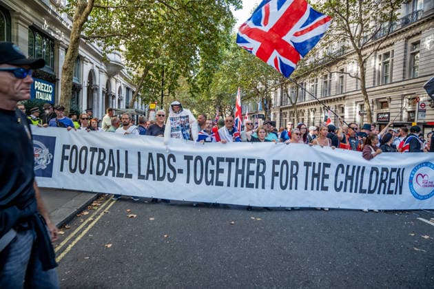 September 26, 2026, London, United Kingdom: Anti-migrant protestors hold a banner during a protest against grooming gangs targeting British girls. The event organised by Together For The Children in collaboration with Football Lads on National Survivors Day stands in solidarity with survivors of child sexual abuse and sexual violence while demanding stronger child protections and legal reforms, as well as a curb on illegal migration. London United Kingdom - ZUMAs197 20260926_aaa_s197_326 Copyright: xLabxMox
