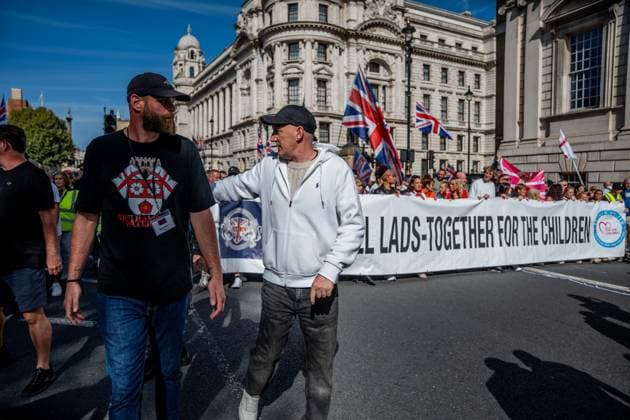 September 26, 2026, London, United Kingdom: Anti-migrant protestors hold a banner during a protest against grooming gangs targeting British girls. The event organised by Together For The Children in collaboration with Football Lads on National Survivors Day stands in solidarity with survivors of child sexual abuse and sexual violence while demanding stronger child protections and legal reforms, as well as a curb on illegal migration. London United Kingdom - ZUMAs197 20260926_aaa_s197_300 Copyright: xLabxMox