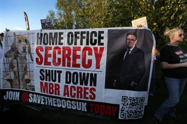 September 26, 2026, Huntingdon, United Kingdom: Animal activists protest outside the main gates of MBR Acres with placards and banners during the protest. Save The Dogs UK march to end animal testing culminating in a rally at MBR Acres in Huntingdon. The facility produces beagle puppies for the vivisection industry. The march to MBR Acres was held at the same time as a two-week march by animal activists in the USA arrived at Marshall BioResources in New York. Both sets of activists claim ™Two Countries, Two Marches. One Shared Message™ The protesters insist both Marshall BioResourses and MBR Acres are closed and demand a future beyond animal testing. Huntingdon United Kingdom - ZUMAs197 20260926_aaa_s197_459 Copyright: xMartinxPopex