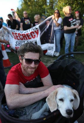 September 26, 2026, Huntingdon, United Kingdom: A protester with his dog in a pram demonstrates outside the main gates of MBR Acres during the protest. Save The Dogs UK march to end animal testing culminating in a rally at MBR Acres in Huntingdon. The facility produces beagle puppies for the vivisection industry. The march to MBR Acres was held at the same time as a two-week march by animal activists in the USA arrived at Marshall BioResources in New York. Both sets of activists claim ™Two Countries, Two Marches. One Shared Message™ The protesters insist both Marshall BioResourses and MBR Acres are closed and demand a future beyond animal testing. Huntingdon United Kingdom - ZUMAs197 20260926_aaa_s197_447 Copyright: xMartinxPopex