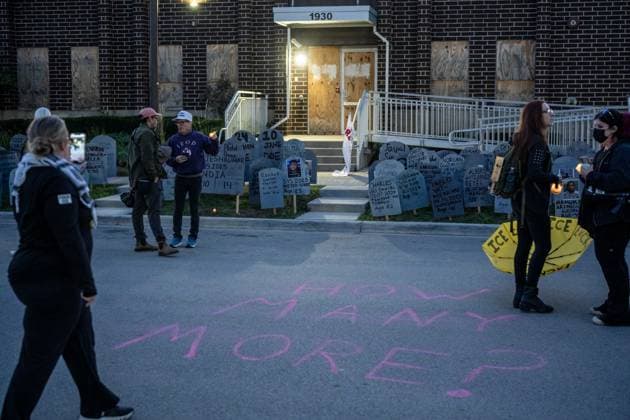 September 26, 2026, Broadview, Illinois, USA: Activists speaking to each other outside the Broadview ICE Detention Facility during a vigil marking the one year anniversary of Operation Midway Blitz in Chicagoland. Cardboard gravestones of those killed in the year since mark the front lawn. Chalk on the ground reads How Many More? Broadview USA - ZUMAr170 20260926_znp_r170_020 Copyright: xChrisxRihax