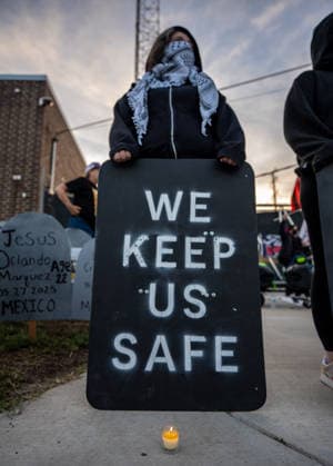 September 26, 2026, Broadview, Illinois, USA: Activist holding a shield that reads WE KEEP US SAFE during a candlelight vigil outside the ICE Detention Facility in Broadview, one year after Operation Midway Blitz Broadview USA - ZUMAr170 20260926_znp_r170_012 Copyright: xChrisxRihax