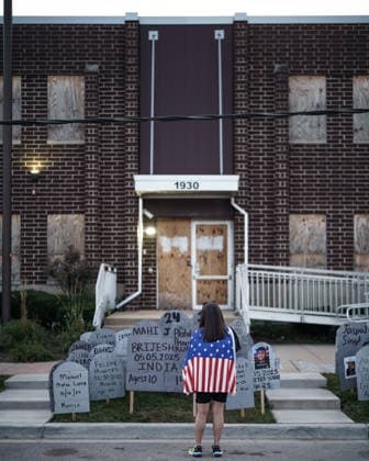 September 26, 2026, Broadview, Illinois, USA: Outside the Broadview ICE Facility, an activist wearing an american flag stands over the cardboard gravestones bearing the names of those killed by ICE or in custody in the one year since Operation Midway Blitz in Chicagoland Broadview USA - ZUMAr170 20260926_znp_r170_013 Copyright: xChrisxRihax
