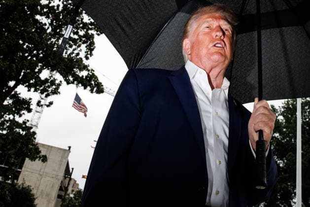 President Donald Trump holds an umbrella as he speaks to the press before departing from the new South Lawn helipad in Marine One on the new South Lawn helipad at the White House on Sunday, September 27, 2026 in Washington, DC. Trump is heading to Medinah, Illinois where he will be attending the PGA Tour President s Cup.  WAX202609278007 SamuelxCorum