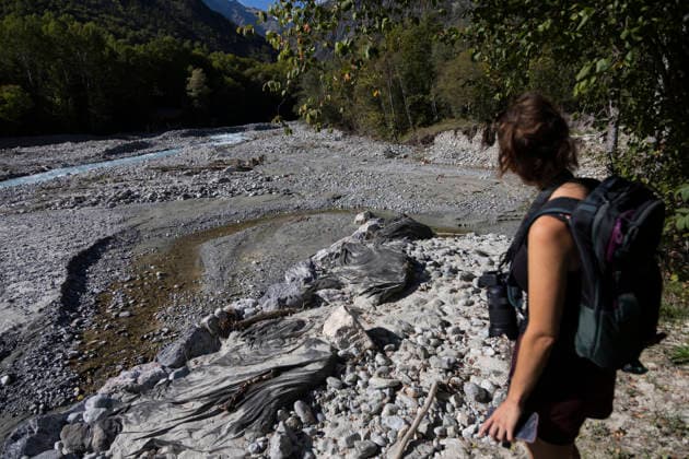 Gyr Flood Damage - France A woman observes the eroded ground and flood deposits beside the Gyr. Vallouise-Pelvoux, Hautes-Alpes, France, September 27, 2026. The exceptional floods of August 28 caused major damage in Vallouise-Pelvoux and on the road to Ailefroide. The damage highlights the growing exposure of Alpine valleys to intense rainfall and torrential hazards in a warming climate. Photo by Thibaut Durand ABACAPRESS.COM Vallouise-Pelvoux PROVENCE-ALPES-COTE D AZUR France  Copyright: xDurandxThibaut ABACAx