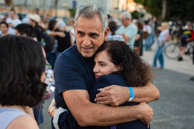 September 27, 2026, Tel Aviv, Tel Aviv, Israel: MK NAAMA LAZIMI of the Democrats embraces MICHEL ILLOUZ, father of slain hostage Guy Illouz at a Sukka, a tent for the holiday of Sukkot, built by families of former hostages In Hostages Square to commemorate 3 years since October 7th Tel Aviv Israel - ZUMAg280 20260927_znp_g280_001 Copyright: xYoavxGinsburgx