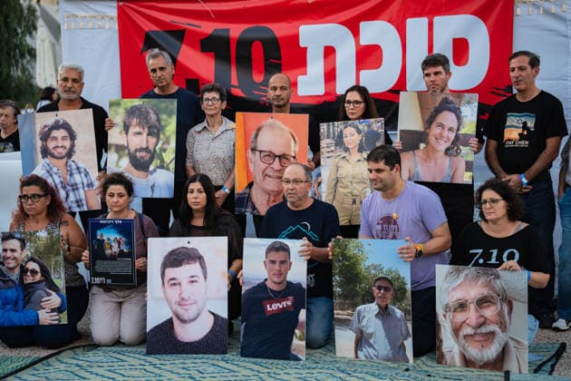 September 27, 2026, Tel Aviv, Tel Aviv, Israel: Former hostage families hold pictures of their dead loved ones at a Sukka, a tent for the holiday of Sukkot, built by the families In Hostages Square to commemorate 3 years since October 7th Tel Aviv Israel - ZUMAg280 20260927_znp_g280_003 Copyright: xYoavxGinsburgx