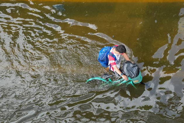 September 28, 2026, Bangkok, Thailand: A view from above of a man pushing his bicycle through the high floodwater on Lat Phrao Road in Bang Kapi District. On September 26, all 50 districts of Bangkok were declared disaster-affected areas. Three days later, floodwaters still remained in parts of the city. In heavily affected areas such as Bang Kapi District, residents remained in floodwater. Bangkok Thailand - ZUMAs197 20260928_aaa_s197_375 Copyright: xNathaliexJamoisx