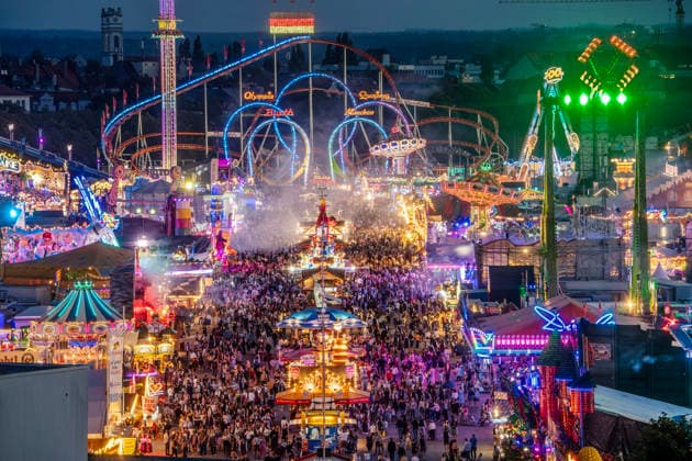 A view from St. Paul’s Church, 50 meters above ground, of the sea of lights at the Wiesn in the evening; the Oktoberfest glows in every