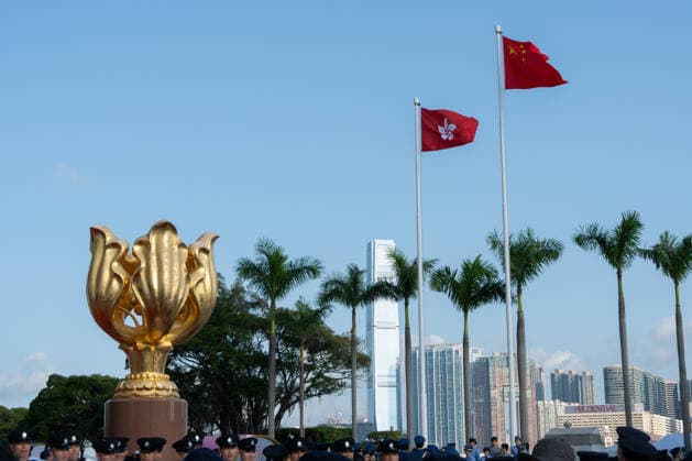HONG KONG-DAILY NATIONAL-DAY A general view shows the national flag of China and the Hong Kong regional flag fluttering atop flagpoles above the Forever Blooming Bauhinia Sculpture at Golden Bauhinia Square following the 77th National Day flag-raising ceremony on October 1, 2026 in Hong Kong. (Photo by Kevin Li TMHK via Nexpher Images) Hong Kong