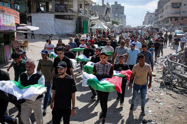 Palestinians Hold Mass Funeral for 105 Recovered from Gaza Rubble Palestinians take part in a mass funeral for 105 Palestinians whose remains were recovered from beneath the rubble of destroyed buildings in the al-Taj area of Gaza City’s al-Yarmouk neighborhood on October 1, 2026. The victims, including women and children, were killed in Israeli airstrikes during the early stages of the war, with families gathering for their funeral and burial after their remains had been trapped under the rubble for years. Photo by Mohammed Salha apaimages Gaza Gaza Strip Palestinian Territory 011026_Gaza_MS_00(10) Copyright: xapaimagesxMohammedxSalhax xapaimagesx