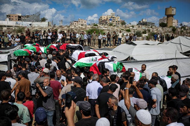 Palestinians Hold Mass Funeral for 105 Recovered from Gaza Rubble Palestinians take part in a mass funeral for 105 Palestinians whose remains were recovered from beneath the rubble of destroyed buildings in the al-Taj area of Gaza City’s al-Yarmouk neighborhood on October 1, 2026. The victims, including women and children, were killed in Israeli airstrikes during the early stages of the war, with families gathering for their funeral and burial after their remains had been trapped under the rubble for years. Photo by Mohammed Salha apaimages Gaza Gaza Strip Palestinian Territory 011026_Gaza_MS_00(14) Copyright: xapaimagesxMohammedxSalhax xapaimagesx