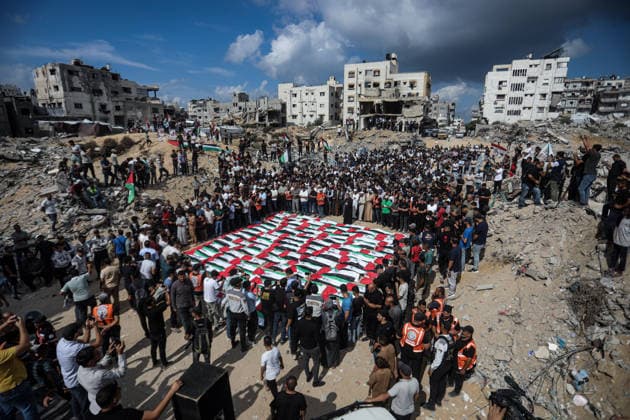 Palestinians Hold Mass Funeral for 105 Recovered from Gaza Rubble Palestinians take part in a mass funeral for 105 Palestinians whose remains were recovered from beneath the rubble of destroyed buildings in the al-Taj area of Gaza City’s al-Yarmouk neighborhood on October 1, 2026. The victims, including women and children, were killed in Israeli airstrikes during the early stages of the war, with families gathering for their funeral and burial after their remains had been trapped under the rubble for years. Photo by Bilal Osama apaimages Gaza city Gaza Strip Palestinian Territory 011026_Gaza_BO_00(10) Copyright: xapaimagesxBilalxOsamax xapaimagesx