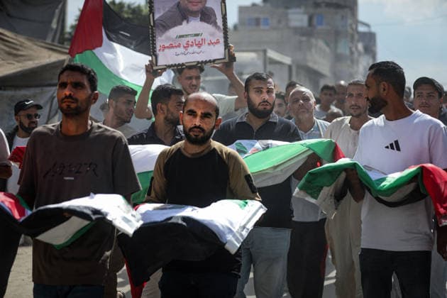 Palestinians Hold Mass Funeral for 105 Recovered from Gaza Rubble Palestinians take part in a mass funeral for 105 Palestinians whose remains were recovered from beneath the rubble of destroyed buildings in the al-Taj area of Gaza City’s al-Yarmouk neighborhood on October 1, 2026. The victims, including women and children, were killed in Israeli airstrikes during the early stages of the war, with families gathering for their funeral and burial after their remains had been trapped under the rubble for years. Photo by Bilal Osama apaimages Gaza city Gaza Strip Palestinian Territory 011026_Gaza_BO_00(13) Copyright: xapaimagesxBilalxOsamax xapaimagesx