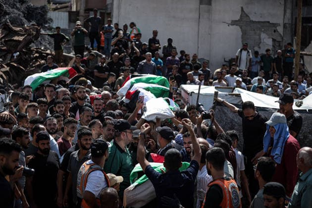 Palestinians Hold Mass Funeral for 105 Recovered from Gaza Rubble Palestinians take part in a mass funeral for 105 Palestinians whose remains were recovered from beneath the rubble of destroyed buildings in the al-Taj area of Gaza City’s al-Yarmouk neighborhood on October 1, 2026. The victims, including women and children, were killed in Israeli airstrikes during the early stages of the war, with families gathering for their funeral and burial after their remains had been trapped under the rubble for years. Photo by Bilal Osama apaimages Gaza city Gaza Strip Palestinian Territory 011026_Gaza_BO_00(25) Copyright: xapaimagesxBilalxOsamax xapaimagesx