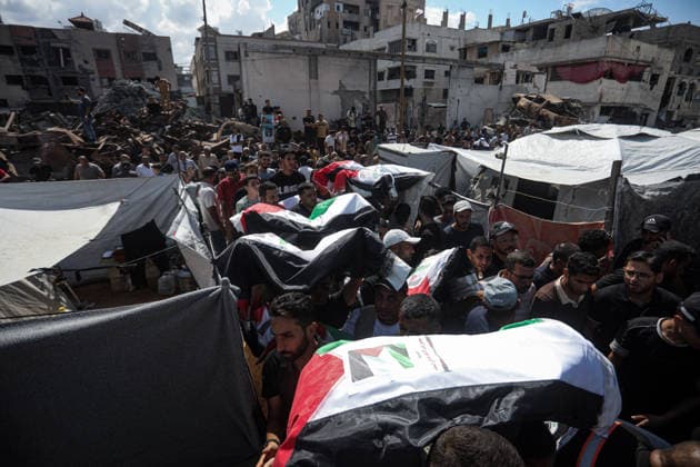 Palestinians Hold Mass Funeral for 105 Recovered from Gaza Rubble Palestinians take part in a mass funeral for 105 Palestinians whose remains were recovered from beneath the rubble of destroyed buildings in the al-Taj area of Gaza City’s al-Yarmouk neighborhood on October 1, 2026. The victims, including women and children, were killed in Israeli airstrikes during the early stages of the war, with families gathering for their funeral and burial after their remains had been trapped under the rubble for years. Photo by Bilal Osama apaimages Gaza city Gaza Strip Palestinian Territory 011026_Gaza_BO_00(32) Copyright: xapaimagesxBilalxOsamax xapaimagesx