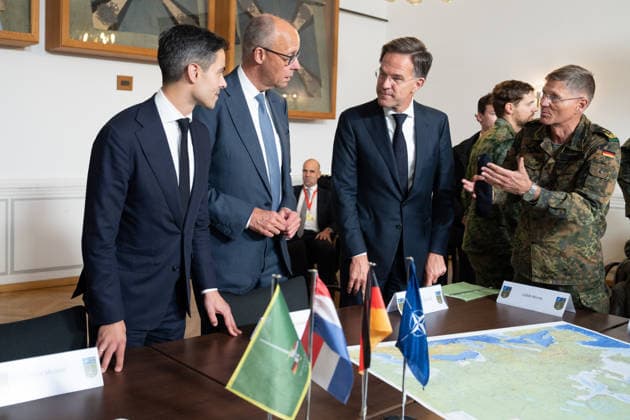 Visit to the German-Dutch Corps by Federal Chancellor Merz and Rob Jetten, Prime Minister of the Netherlands, together with Federal Chancellor Friedrich Merz, NATO Secretary General Mark Ruette listen intently to the remarks by Lieutenant General Peter Mirow, who is holding a map of Europe during a visit to the 1st German-Dutch Corps, Münster, October 1, 2026, Münste