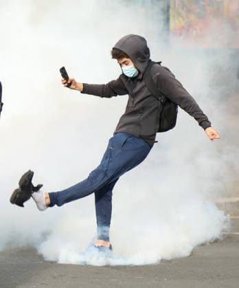 Student protest in Paris PARIS, FRANCE - SOCTOBER 1: A Protester kicks tear gas canister amid clashes with French riot police during a protest by high school and university students near Lycee Paul Eluard high school in Saint-Denis, near Paris, France, on October 1, 2026. Mohamad Salaheldin Abdelghani Alsayed Anadolu Paris France. Editorial use only. Please get in touch for any other usage.  Copyright: x2026xAnadoluxMohamadxSalaheldinxAbdelghanixAlsayedx