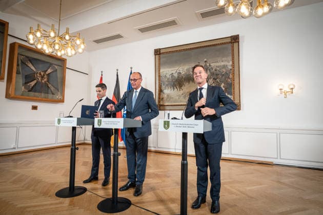 Friedrich Merz, Chancellor of Germany (center), with Rob Jetten, Prime Minister of the Netherlands (left), and Mark Rutte, NATO Secretary General (right), during the closing remarks at a meeting between the German Chancellor, the Prime Minister of the Netherlands, and the NATO Secretary General at the 1st German-Dutch Corps in Münster, Münster, North Rhin