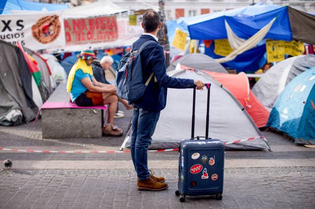 Fifth day of the housing protest camp in Madrid, Spain - 01 Oct 2026 A man with a suitcase observes the encampment in Puerta del Sol square in central Madrid, during a protest camp against the high cost of housing and rent in Spain. The protest arose following the eviction of an 87-years-old woman from her apartment in Madrid. Madrid Spain Copyright: xLuisxSotox xSOPAxImagesx LSOTOQDA01