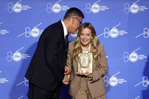 IPA89184696 - Rome, Italy October 1, 2026 CNA President Dario Costantini presents an award and a bouquet of flowers to Giorgia Meloni. Celebrations marking the 80th anniversary of the CNA are taking place at the Antonianum Auditorium. Prime Minister Giorgia Meloni is expected to attend the event at 5:00 p.m. for a gathering dedicated to the world of Italian crafts and small and medium-sized enterprises. Copyright: xmarcoxiacobuccix xmarcoxiacobuccix IPA89184696